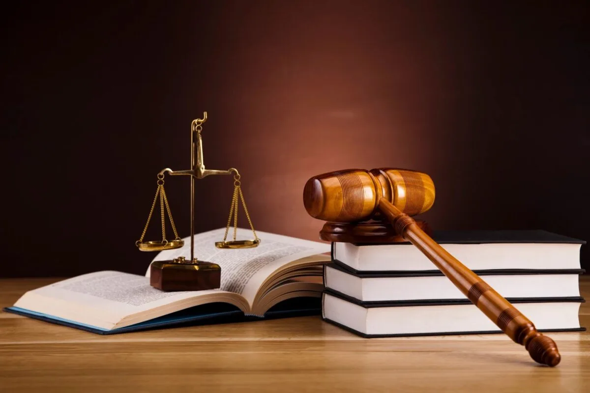 Stack of law books with judge gavel on top
